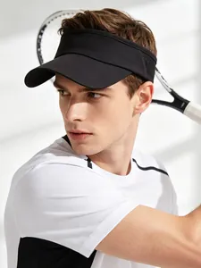 Side view of man wearing a black sports sun visor hat while holding a tennis racket