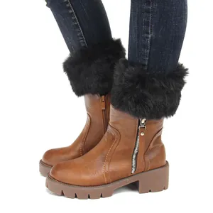 Close-up detail of soft black faux fur boot cuffs worn with stylish brown boots