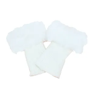 Close-up detail of white knitted winter boot cuffs with plush faux fur trim and ribbed texture