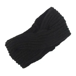 Close-up detail of handmade black knitted twisted headband with soft yarn texture