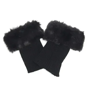 Close-up detail of black knitted boot cuffs featuring soft faux fur trim decoration