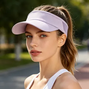 Detailed view of a model wearing a lavender outdoor sun visor hat in a bright park.
