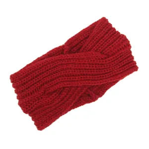 Close-up of a red chunky knitted cross headband showing detailed handmade yarn texture