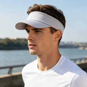 Close-up of a light gray breathable mesh sun visor worn by a male model outdoors