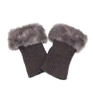 Macro view of dark grey knitted boot cuffs featuring a soft grey faux fur trim detail.
