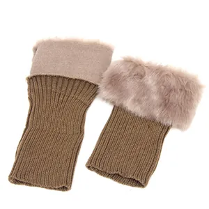 Detailed close-up of brown knitted boot cuffs with plush faux fur trim accessory.