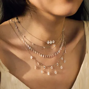 Detailed view of layered S925 sterling silver necklaces with sparkling waterdrop tassels.