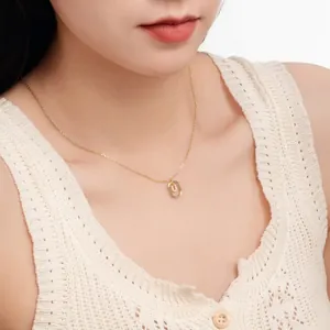 Close-up of a dainty gold-plated S925 sterling silver necklace with a letter 'D' pendant