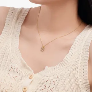 Close-up of a delicate S925 sterling silver necklace with a hollow letter U pendant