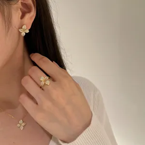 Close-up showing the intricate pavé-set crystals of a floral jewelry set on a model.