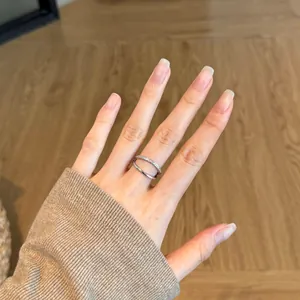Close-up of a minimalist S925 sterling silver double-layered ring worn on a finger