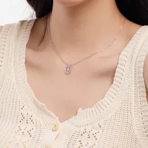 Close-up of S925 sterling silver necklace with sparkling rhinestone letter R pendant