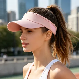 Close-up of a pink mesh sun visor for outdoor sports worn by a model in sunlight