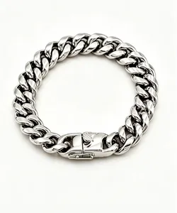 Macro detail of thick stainless steel Cuban link bracelet with heavy-duty clasp