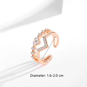 Detail of adjustable V-shaped double-layer rose gold ring with heart zircons.