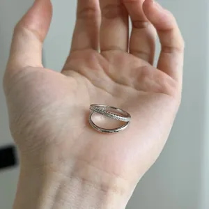 Detailed view of S925 sterling silver stackable ring with pavé-set stones on a palm