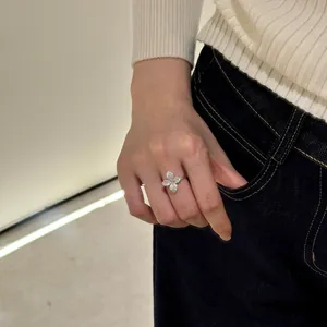 Macro view of a S925 sterling silver four-petal flower ring with shiny pavé setting
