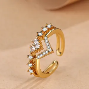Detail view of a V-shaped double-layered gold ring with heart-shaped cubic zirconia.