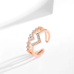 Detail view of a rose gold double-layer V-shaped open ring featuring heart zircon stones.