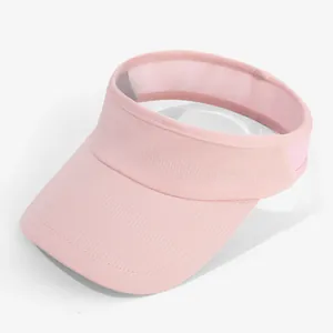 Macro view of pink empty top sun visor hat highlighting breathable mesh fabric texture.