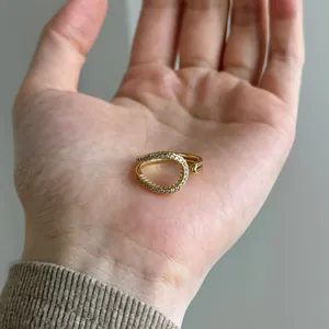 Detailed view of irregular gold-plated S925 silver ring held in palm for scale