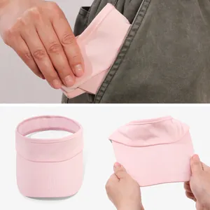 Foldable pink sun visor hat being easily stored in a pocket for outdoor portability