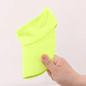 Detailed view of a bright neon green breathable sun visor hat being held in hand