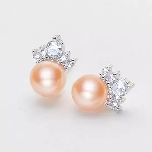 Elegant close-up view of 8mm pink freshwater pearl stud earrings with crown zircon settings