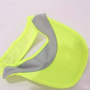 Close-up detail of a neon yellow breathable mesh sun visor with grey inner sweatband