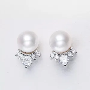 Close-up detail of 8mm freshwater pearl stud earrings with crown zircon setting