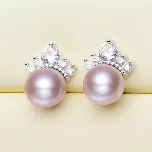 Close-up of crown design pink freshwater pearl stud earrings with zircon accents