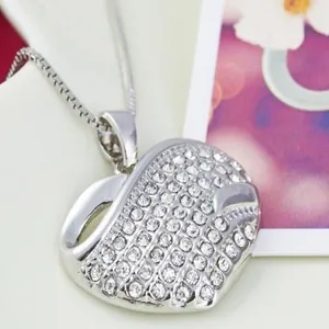 Macro view of a sparkling heart pendant necklace fully encrusted with clear crystals
