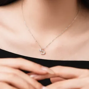 Close-up detail of a delicate S925 sterling silver necklace with a D letter pendant