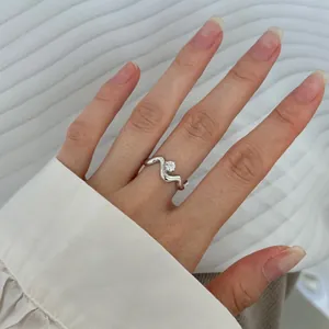 Detailed view of a minimalist S925 sterling silver ring featuring an irregular wavy design.