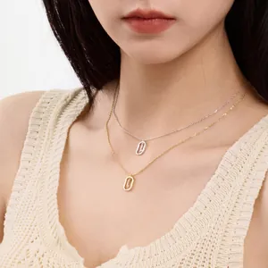 Detailed view of S925 sterling silver and gold alphabet necklaces worn on an Asian model