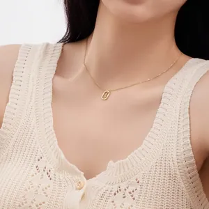 Detailed shot of a delicate S925 sterling silver hollow letter necklace on a model