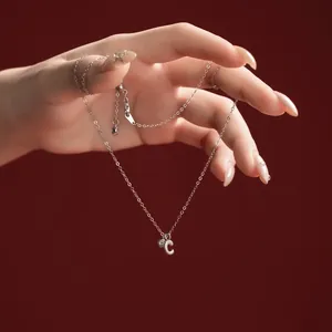 Detailed view of an S925 sterling silver necklace featuring a letter C pendant and heart