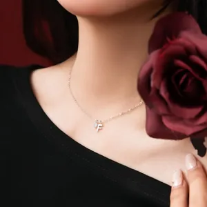 Detailed view of S925 sterling silver necklace featuring letter F and zircon charm