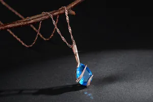 Macro view of blue teardrop crystal pendant necklace with brilliant sparkle effects