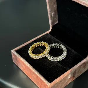 Detail view of two sparkling S925 sterling silver eternity rings in a pink velvet box.