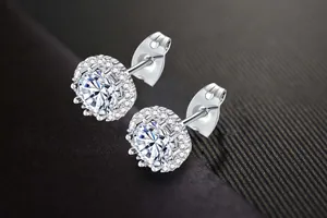 Close-up detail of sparkling round zircon halo stud earrings in silver finish