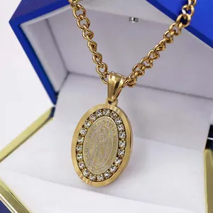 Gold oval rhinestone pendant necklace featuring Our Lady of Guadalupe displayed in a gift box