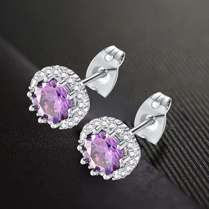 Elegant silver halo stud earrings featuring a brilliant round purple cubic zirconia center.