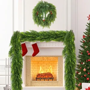 Lush artificial Christmas cedar garland and matching wreath displayed on a white fireplace