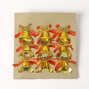 Close-up of nine gold Christmas bells with red bows and Merry Christmas lettering.