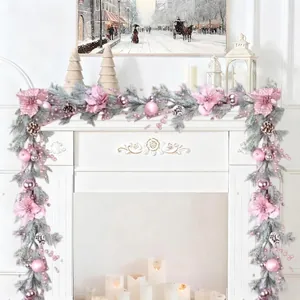 Pink Christmas garland with flowers and berries decorating a white fireplace scene