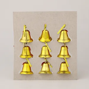 Detailed view of nine-pack golden Christmas bells with embossed star patterns for tree decor.