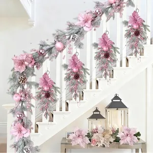 Elegant pink Christmas garland with poinsettias and frosted berries on white stairs