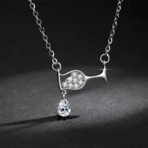 Close-up of elegant wine glass necklace with sparkling teardrop zircon pendant