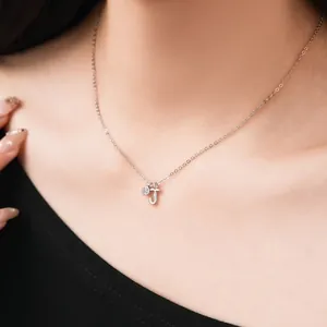 Close-up of S925 sterling silver necklace with letter J and small zircon pendant